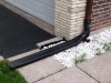 Downspout extension over sidewalk